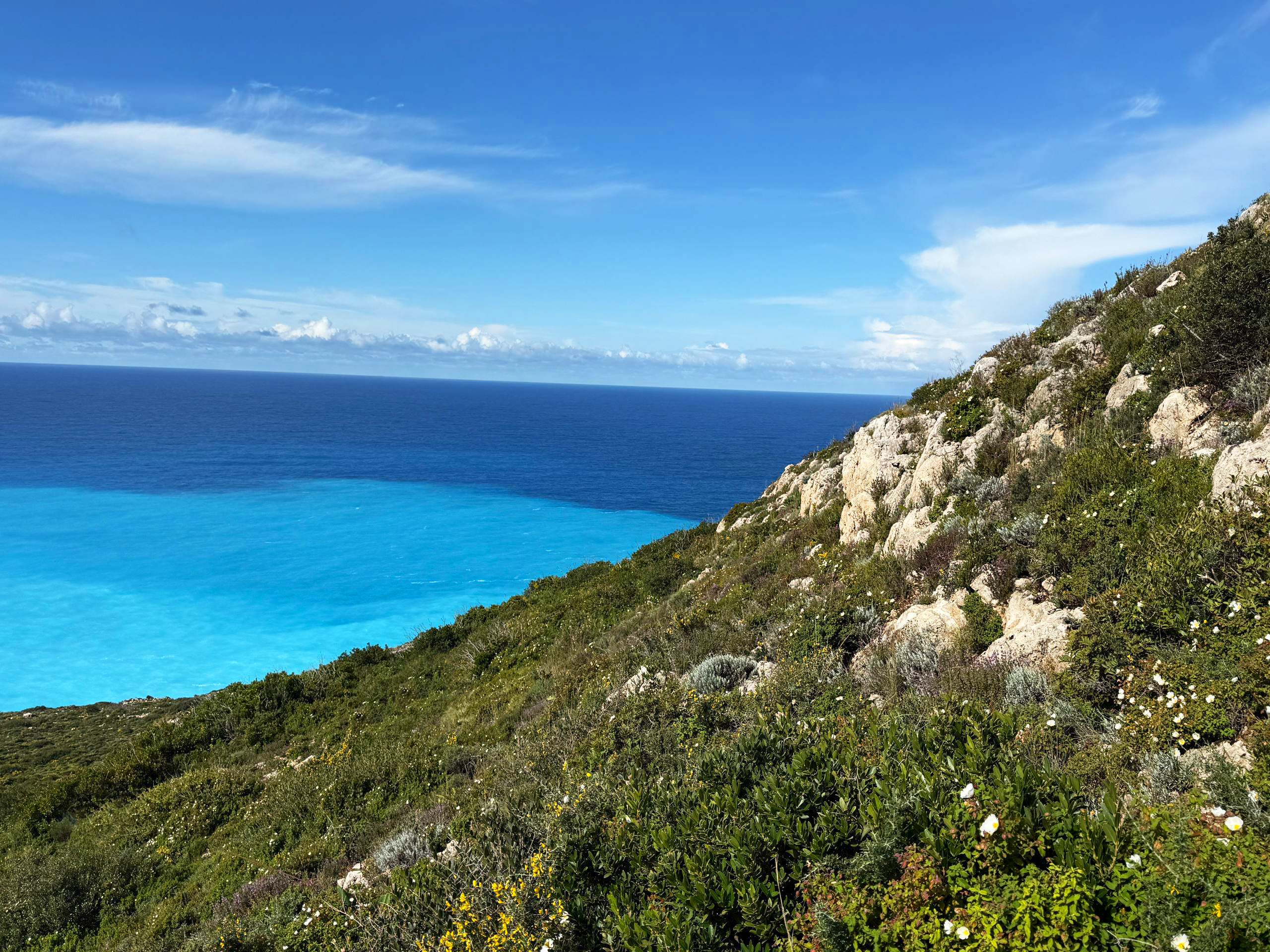 Scenic coastline near Keri with turquoise water and rocky formations